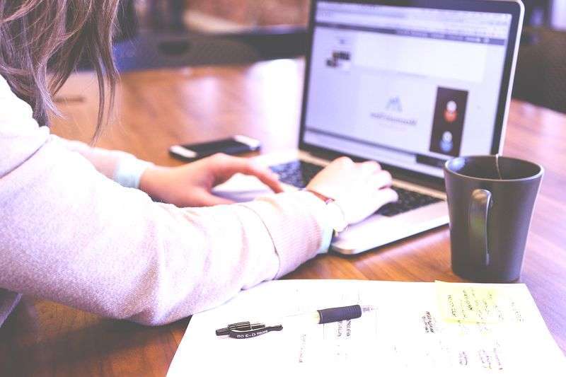 ノートパソコンで在宅勤務する女性。