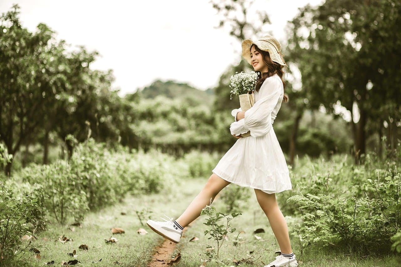 笑顔で花束を運ぶ美少女。