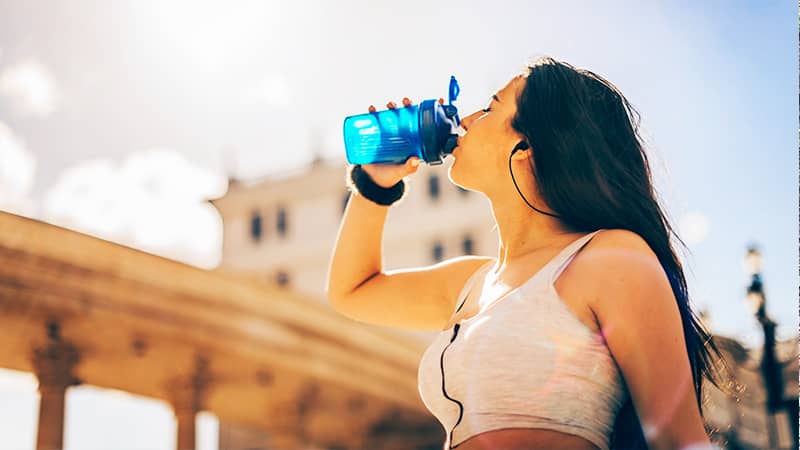 Beautiful woman drinking AQUARIUS